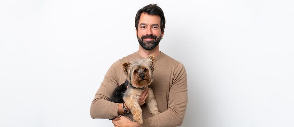 A profile photo of a Background Actor holding his small dog.