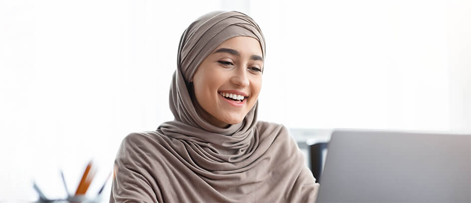 Woman watching Virtual Visiting on a laptop.