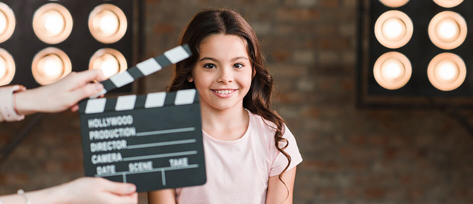 A young girl acting on set.