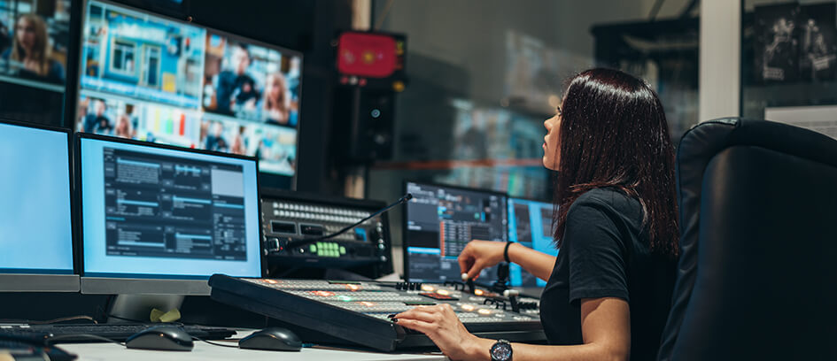 Film editor looking at monitors.