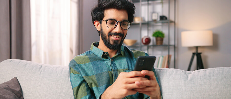 Man responding to messages on a cell phone.