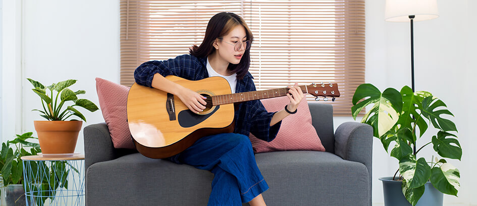 Woman playing a guitar.