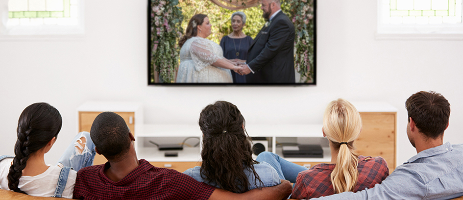 People on couch watching TV ratings network winner This is Us.