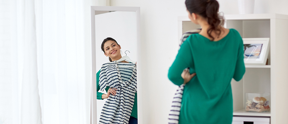 Woman trying on clothes for working on set.